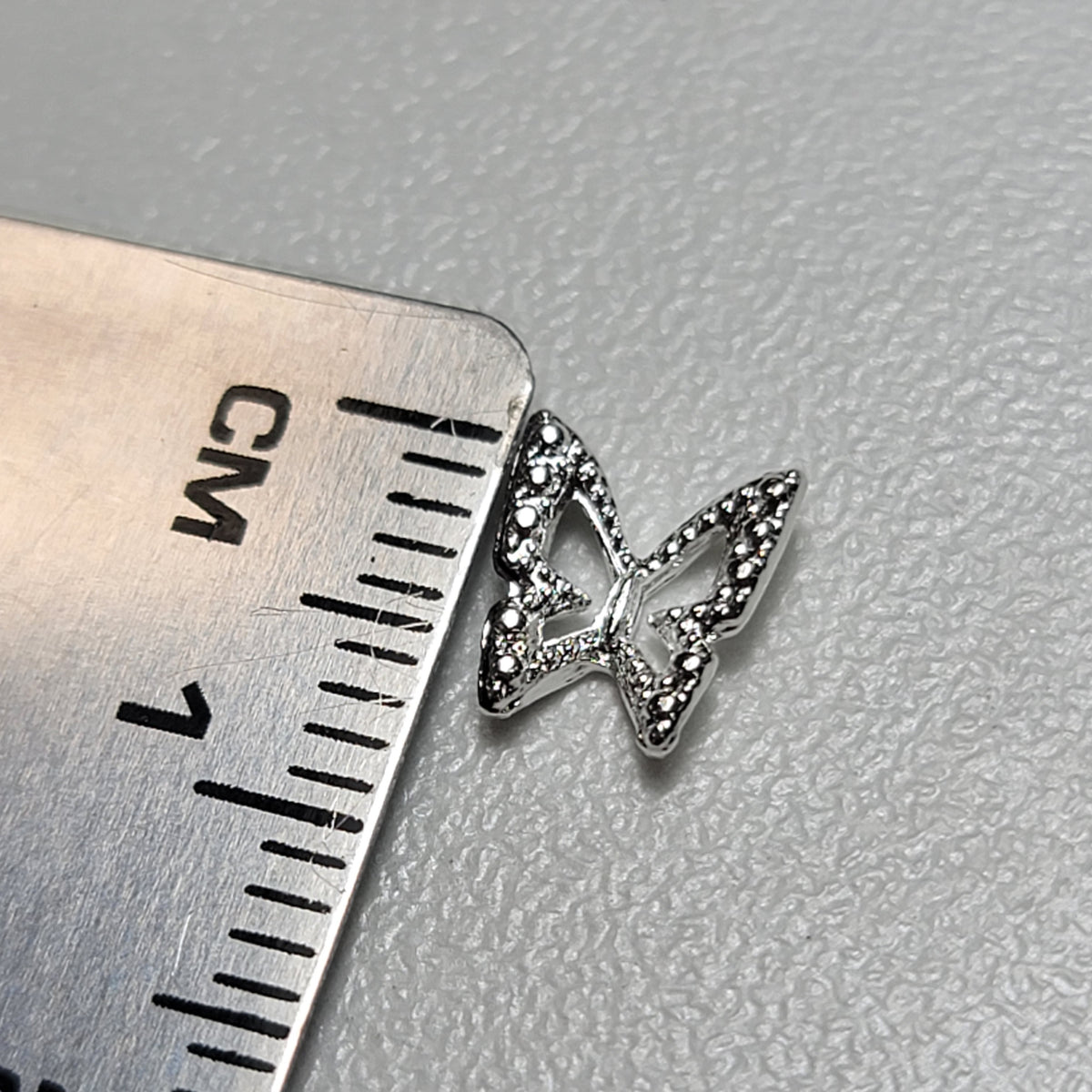 PETIT PAPILLON 0.6 CM ARGENT REFLET